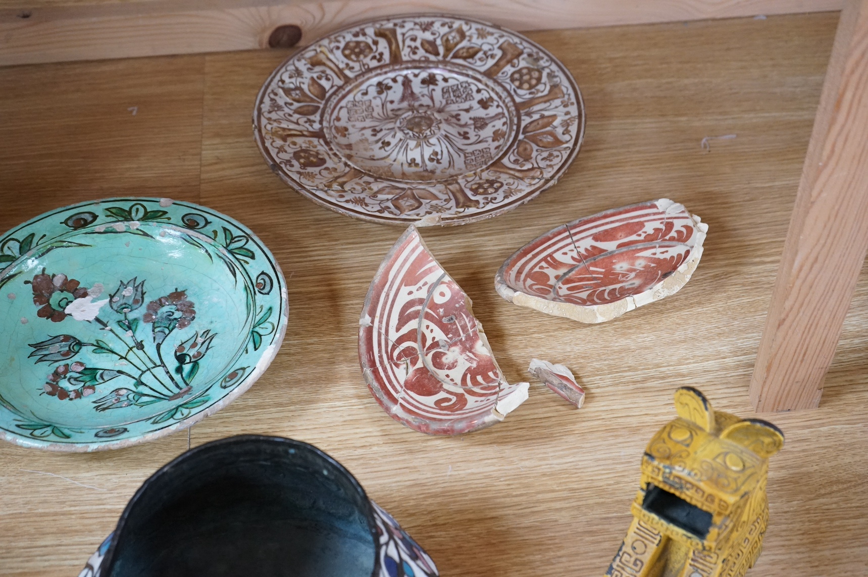 A 16th / 17th century Hispano Moresque copper lustre dish, together with other ceramics, largest 26cm in diameter. Condition - varies